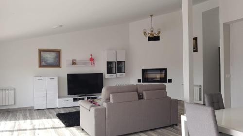 a living room with a couch and a flat screen tv at Apartamento Buenavista in Villamiel