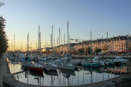 a bunch of boats are docked in a harbor at Appartement fraîchement rénovée - Jacuzzi au cœur de Caen in Caen