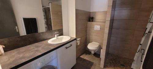 a bathroom with a sink and a toilet at Larimar Etablissement- 200 M de la mer in Sainte-Maxime