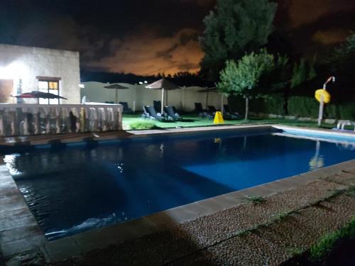 a swimming pool in a yard at night at Los Duendes in El Puerto de Santa María