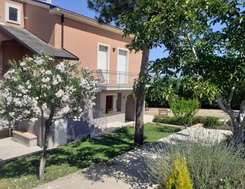 a garden in front of a house with trees at Villa Nonno Nicola in Montenero di Bisaccia