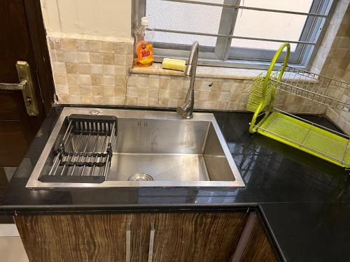 a stainless steel sink in a kitchen with a window at Vactional Villa Dha Phase 6 Lahore ,Three Bed Room Full House in Lahore