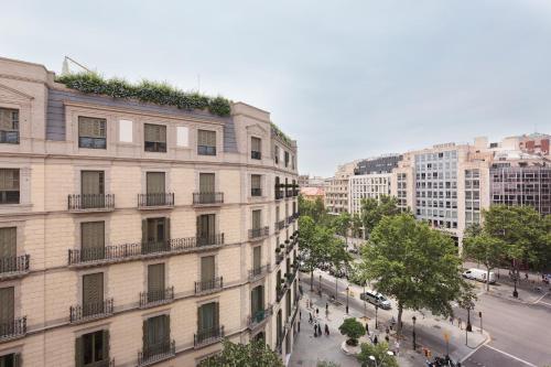 an apartment building with plants on the top of it at Hostal Oliva in Barcelona