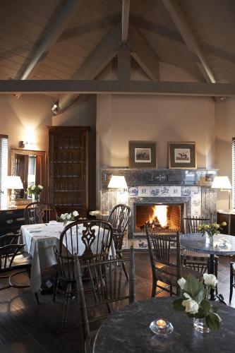 a dining room with tables and a fireplace at Aegli Arachova in Arachova