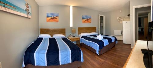 a hotel room with two beds in a room at Wasaga Motel Inn in Wasaga Beach