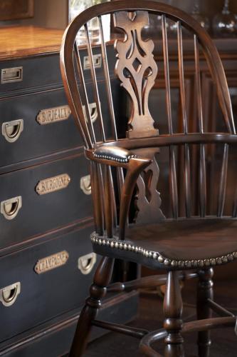 a wooden chair sitting next to a chest of drawers at Aegli Arachova in Arachova
