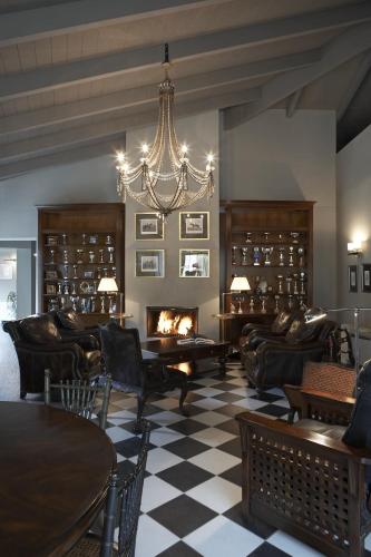 a living room with leather furniture and a fireplace at Aegli Arachova in Arachova