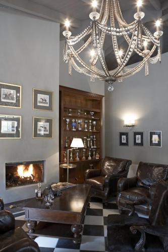 a living room with a chandelier and a fireplace at Aegli Arachova in Arachova