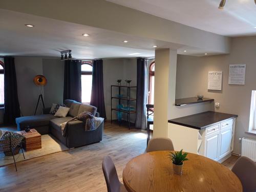 a living room with a couch and a table at Luxary apartment on top of Walbrzych in Wałbrzych
