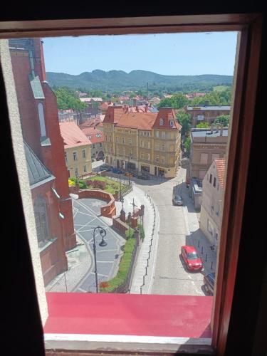 a view of a city street from a window at Luxary apartment on top of Walbrzych in Wałbrzych
