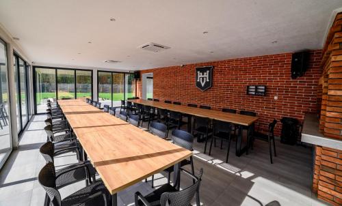 a room with tables and chairs and a brick wall at Villa Hills in Bijeljina