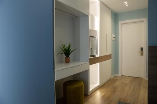 a living room with a fireplace and a blue wall at Veranda Boutique Hotel in Vlorë