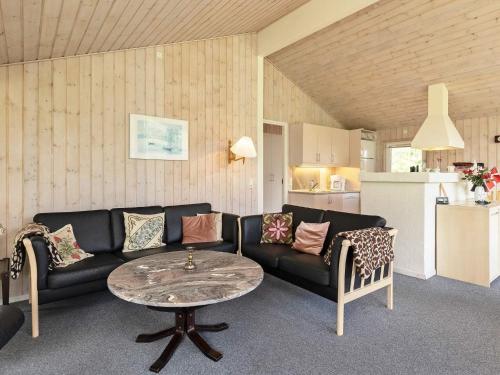 a living room with a couch and a table at 6 person holiday home in Bindslev-By Traum in Stabæk