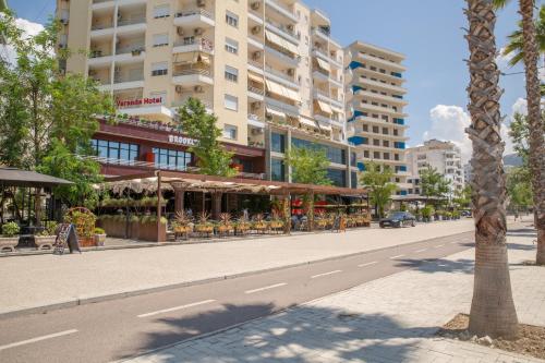 an empty street in a city with a tall building at Veranda Boutique Hotel in Vlorë