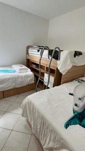 a room with two beds and a desk with a mask on the bed at Cimarron Suites Playa Parguito in Aricagua