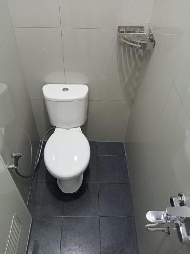 a bathroom with a white toilet in a stall at Srikandi Baru Inn Blok O in Bantul