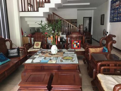 a living room with a table and chairs at Ki Nô Homestay in Hoi An