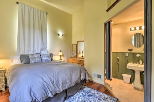 a bedroom with a bed and a sink and a mirror at Charming Apartment in Downtown Blue Lake! in Blue Lake