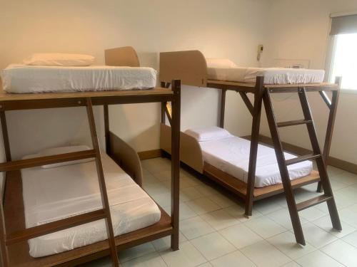 a group of bunk beds in a room at Nacho Hostel Cebu in Bulacao