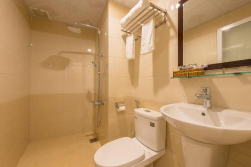 a bathroom with a toilet and a sink and a shower at The Samson - Beach Boutique Hotel in Da Nang