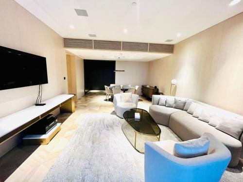 a living room with a couch and a tv at FIVE Palm Jumeirah Resort - 2 Bedrooms plus Maids and Private Jacuzzi - ModernLux in Dubai