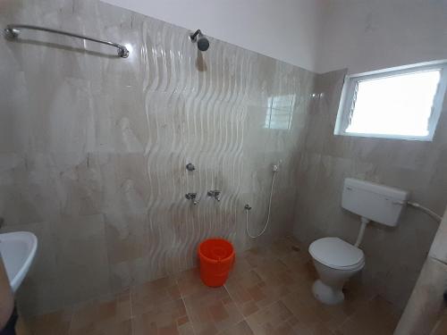 a bathroom with a toilet and a sink at SUPREME RESIDENCY in Coimbatore