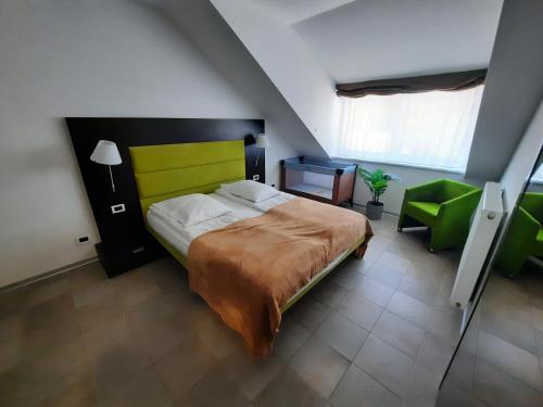 um quarto com uma cama verde e uma cadeira verde em Klass 302 em Kranjska Gora