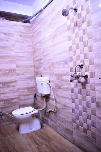 a bathroom with a toilet and a shower at DS Residency-Near Varanasi Jn Railway station N Temples-Parking-Free Wi-Fi in Varanasi