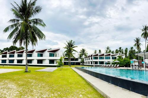 a view of the resort with a swimming pool and palm trees at TASALA cabana 