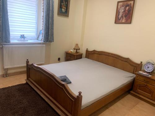 um quarto com uma cama de madeira e uma janela em Ubytování v apartmánu, 2 ložnice, na farmě em Bžany