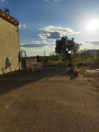 a table and chairs sitting on the side of a building at Casa la Era in Salas Bajas