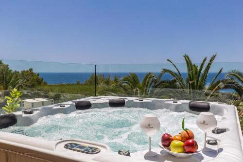 a hot tub with a bowl of fruit in it at Villa Chef Cuisine in Costa d'en Blanes