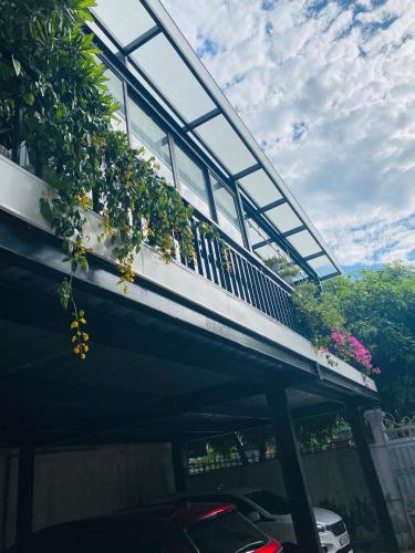 a building with a balcony with plants on it at Khách sạn AMI in Vinh