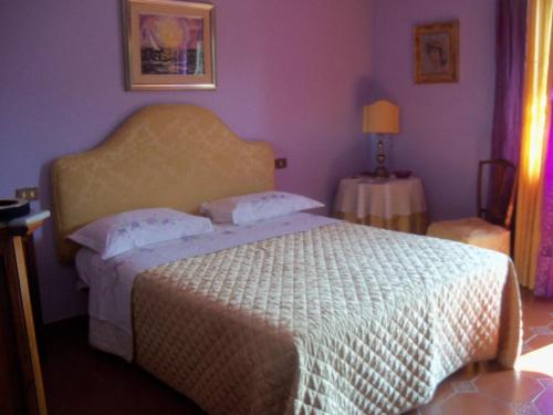 Un pat sau paturi într-o cameră la Tavernamici