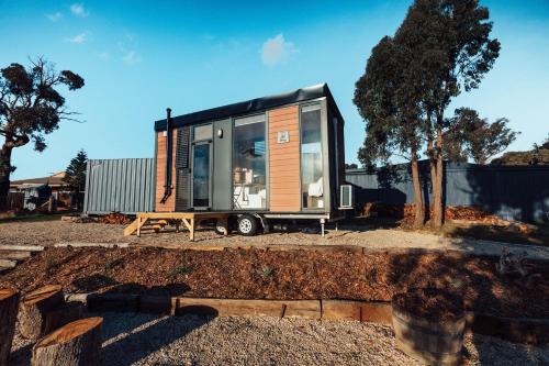 a tiny house is parked in a yard at Farm Stay at Sheltered Paddock 