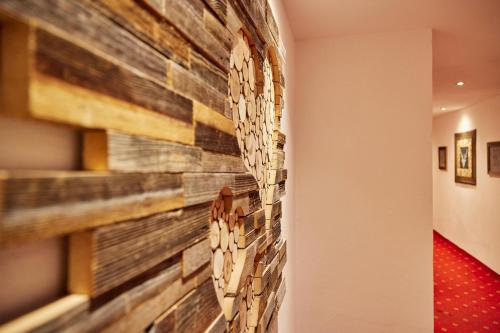 a wall of reclaimed wood in a hallway at Alpenhotel Rieger in Mittenwald