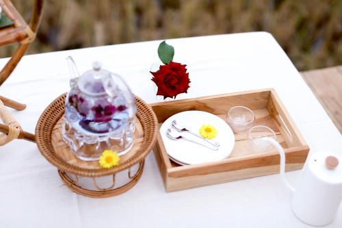 a table with a tray with a plate and a tea set at ลองนอนนา Long Non Na in Ban Lao