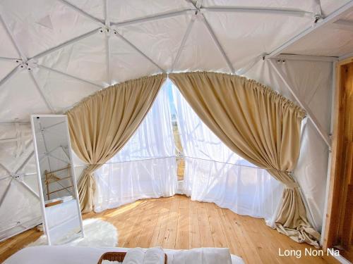 a room with a large window in a yurt at ลองนอนนา Long Non Na in Ban Lao