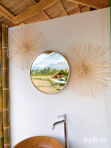 a bathroom with a mirror above a sink at ลองนอนนา Long Non Na in Ban Lao