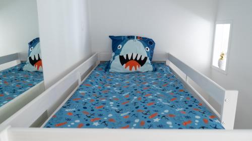a bedroom with two beds with a shark bed at LITTLE MAMA including free parking at 100 meters in Colmar