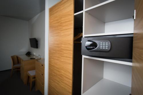 a kitchen with a microwave in a room at Hotel Atom Třebíč in Třebíč