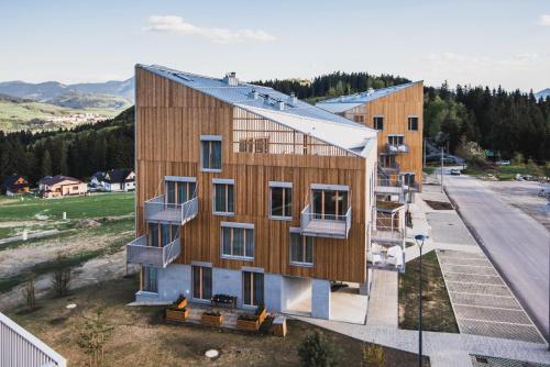 an aerial view of a building with wood panels at Na Kubinke, Hillside in Dolný Kubín