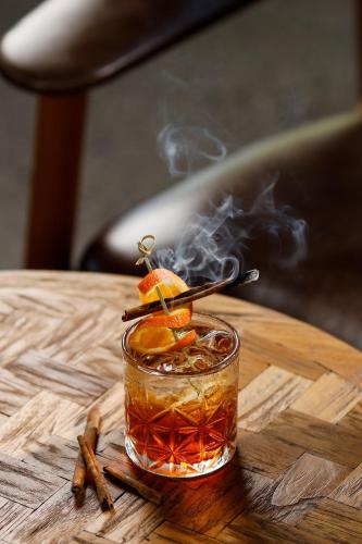 a drink with smoke in a glass on a table at Segara Village Hotel in Sanur