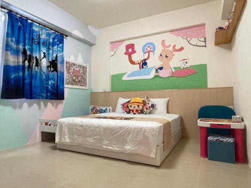 a bedroom with a bed and a painting on the wall at 芹菜芋頭親子民宿 in Taitung City