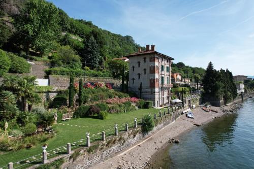 a building on the side of a river next to a building at Villa Marina - Como lake in Bellano