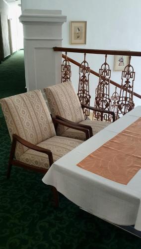 a hotel room with a bed and a couch at Villa Dagmar in Luhačovice