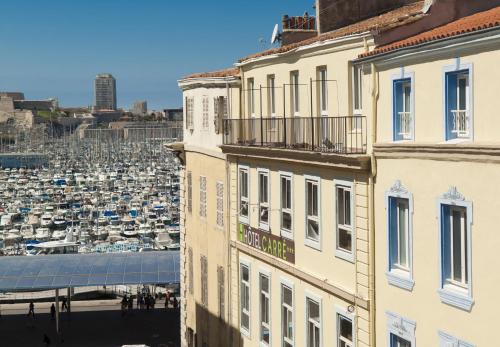 a building with a view of a harbor at Hôtel Carré Vieux Port in Marseille