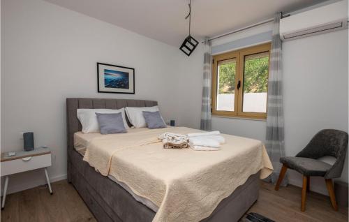 A bed or beds in a room at Amazing Home In Baska Voda With House Sea View