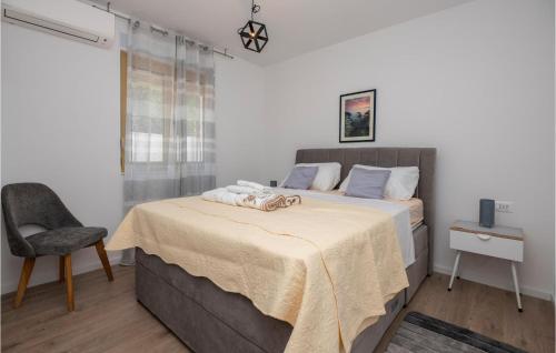 a bedroom with a bed with a table and a chair at Holiday Home Villetta Belveder in Baška Voda