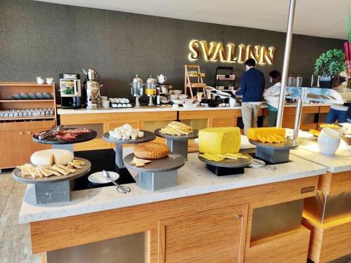 a counter with food on it in a restaurant at Svalinn Hotel in Izmir